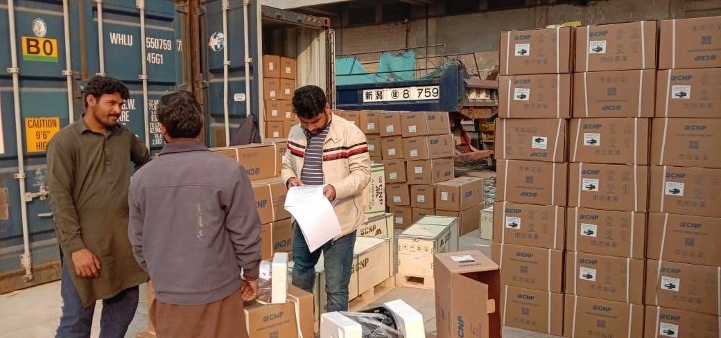 ZTC Logistics staff checking documents against a consignment